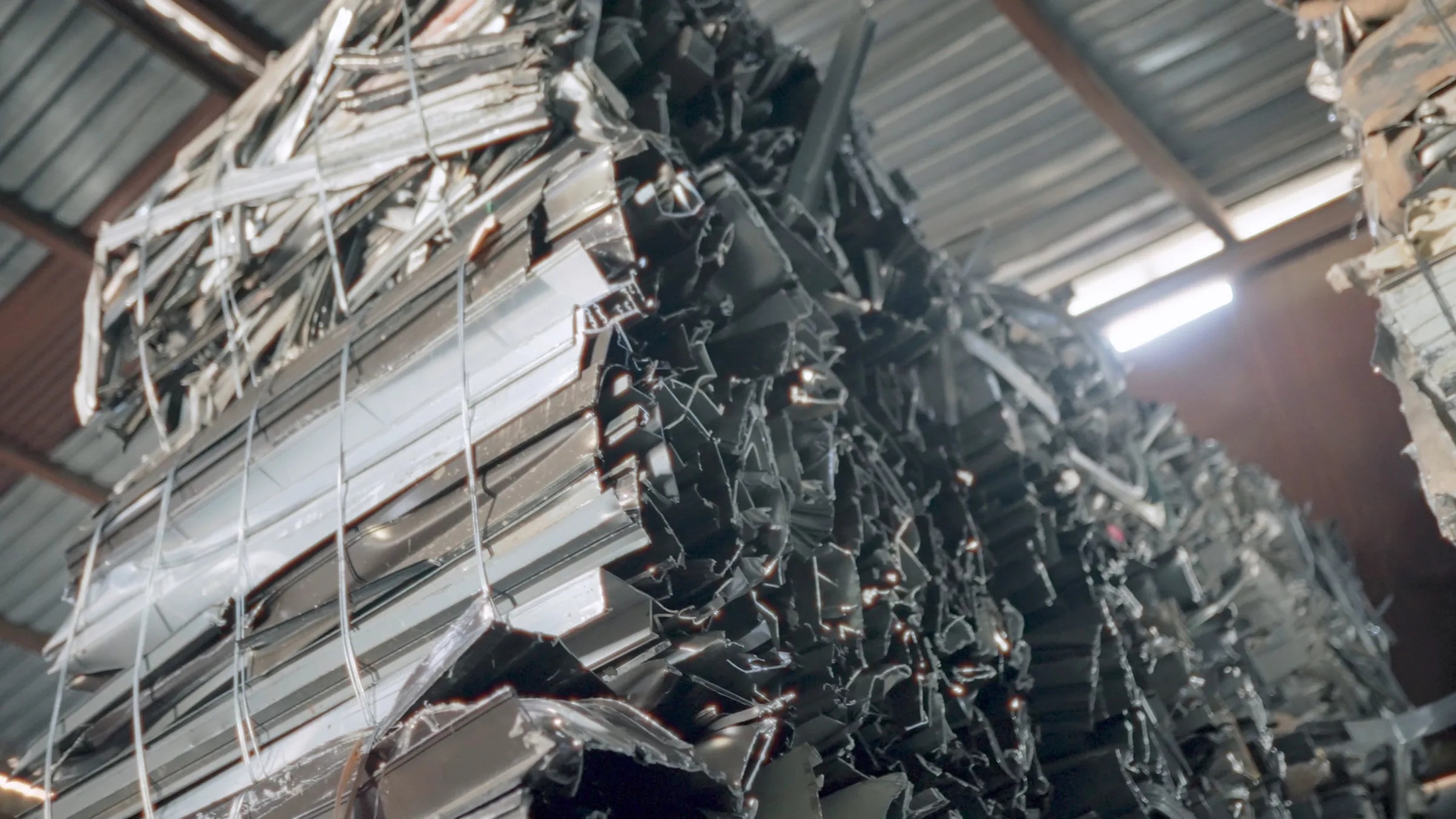 Close cinematic view of bundled black and silver recycling material.