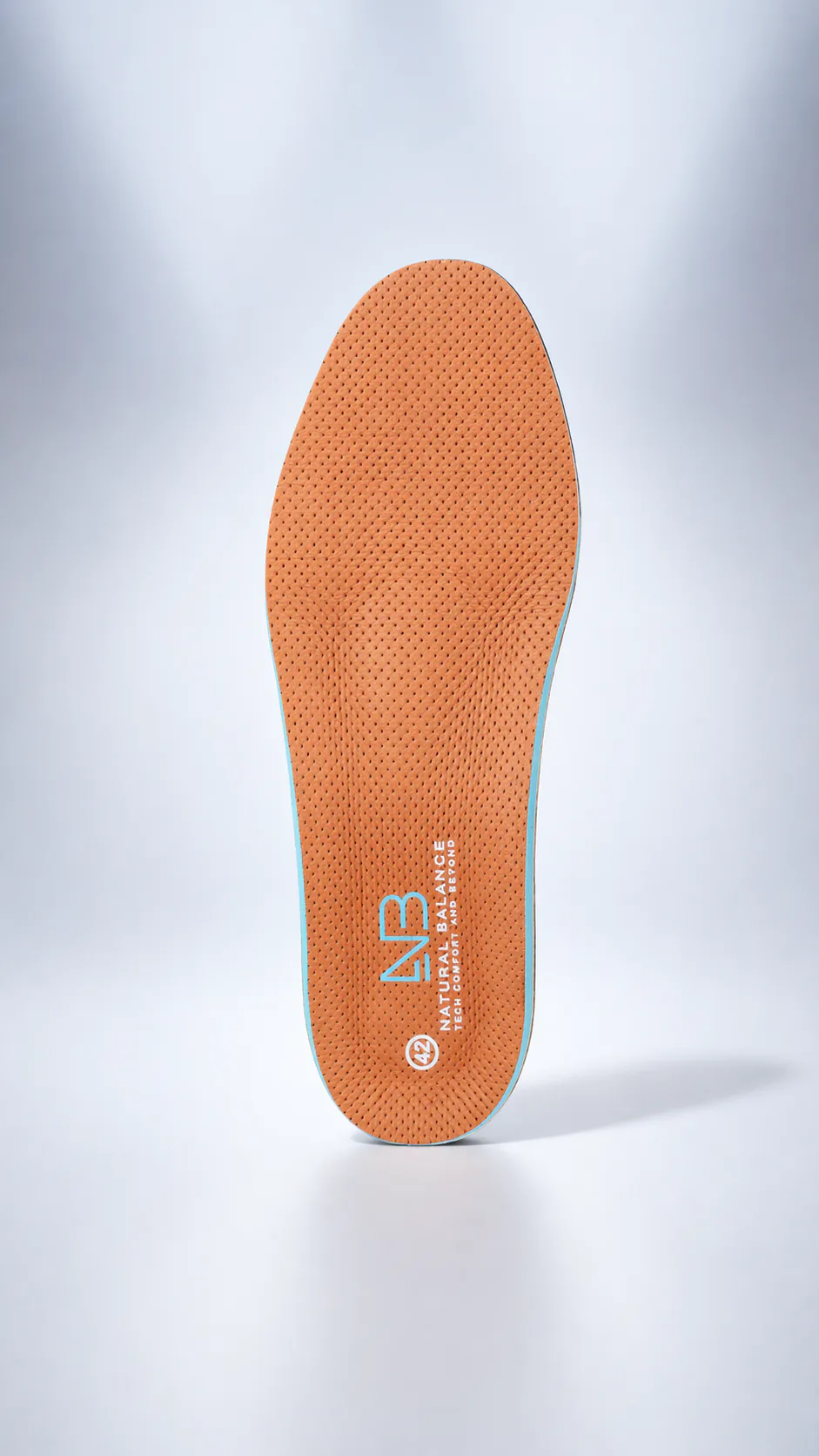 An orange Natural Balance insole standing upright in a clean product frame.