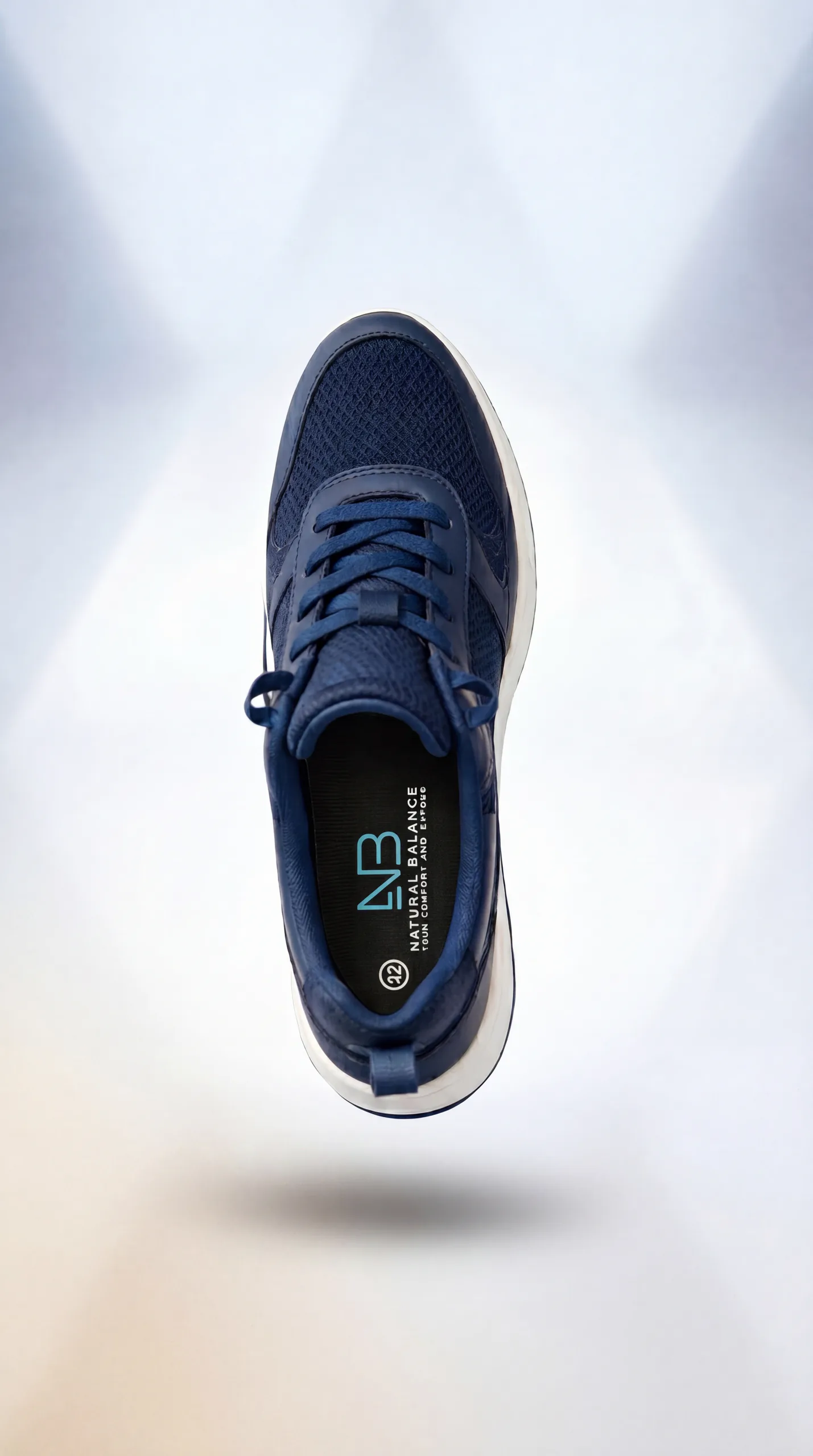A navy Natural Balance sport shoe shown from above with the branded insole visible.