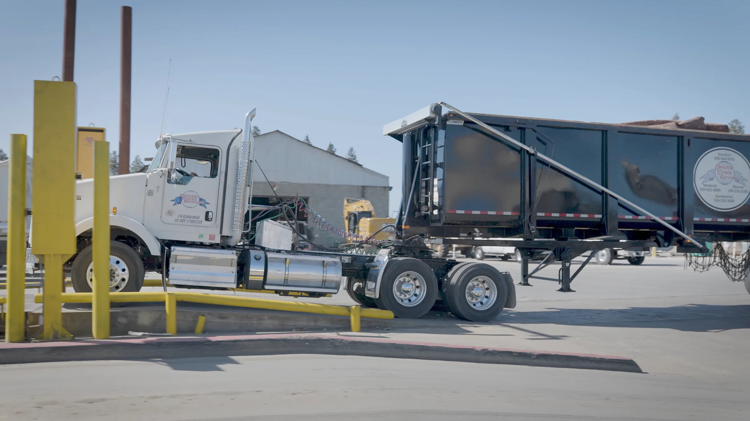 A recycling truck moving through a working yard in a ReSpark campaign film.